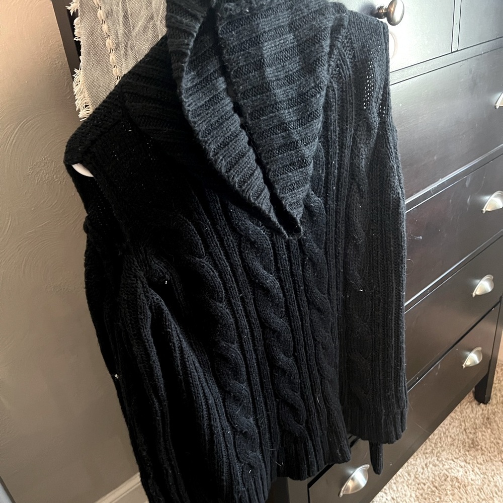 Black cozy sweater with slits in the shoulders.